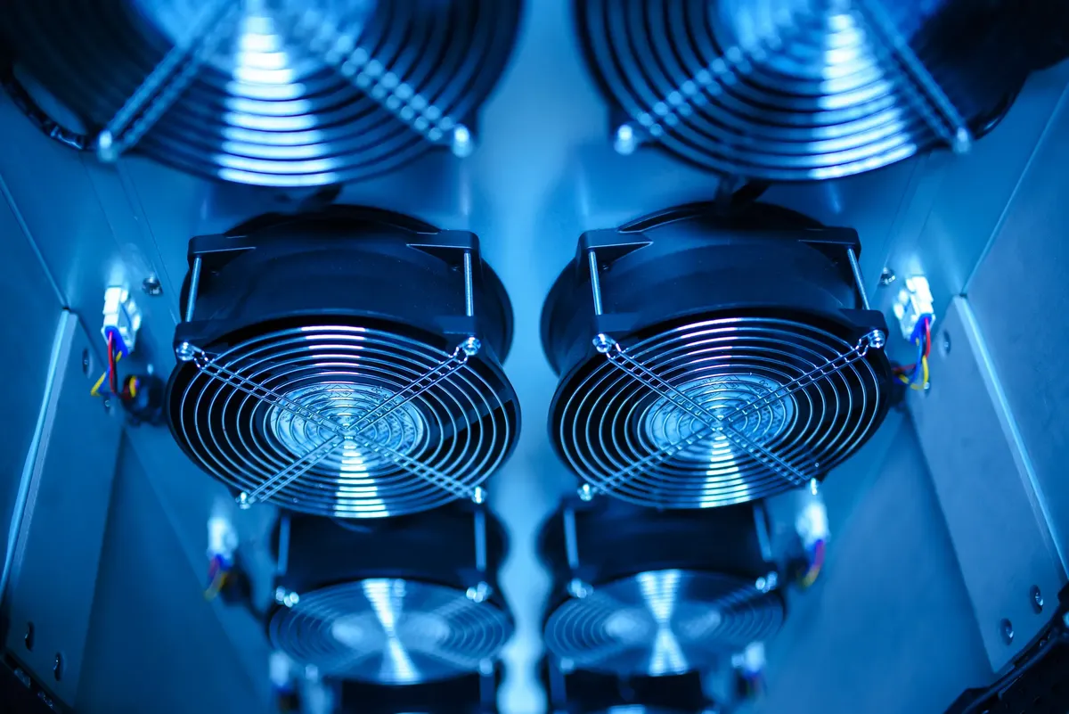 Close-up of cooling fans in a server room, showcasing technology and efficiency.